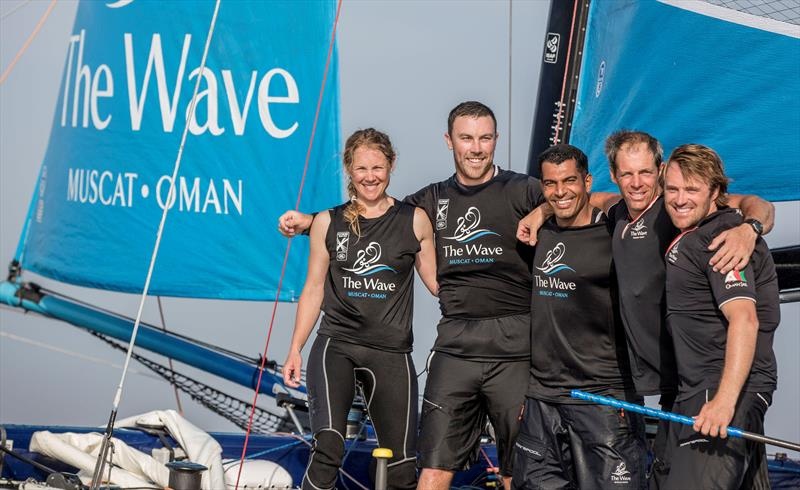 Oman SailFree Para Sailing team members celebrating victory