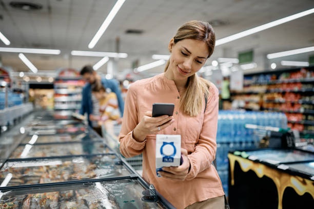 A person scanning a QR code on a product package in a store