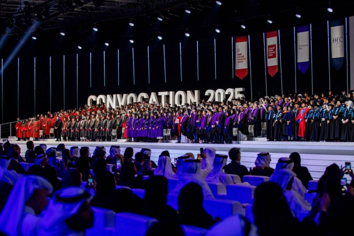 Group photo of QF graduates on the stage