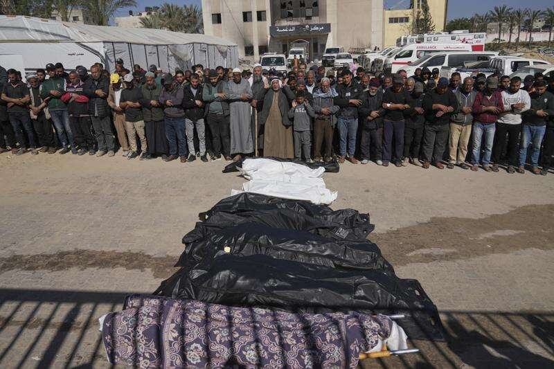 Mourners praying at a funeral for victims in Khan Younis after the Israeli strike.
