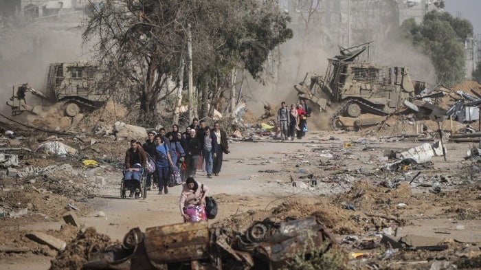 Aftermath of an airstrike in Gaza showing destruction and smoke.