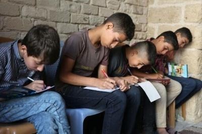 Children in Gaza happily returning to their makeshift school classrooms